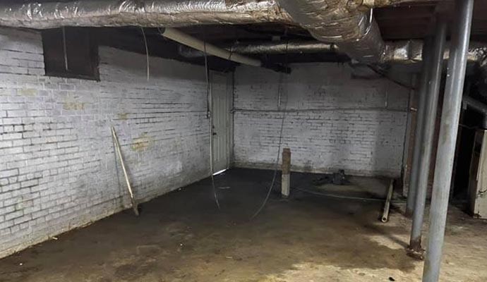 A leaking basement with exposed pipes