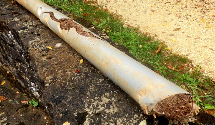 A damaged pipe on a stone surface