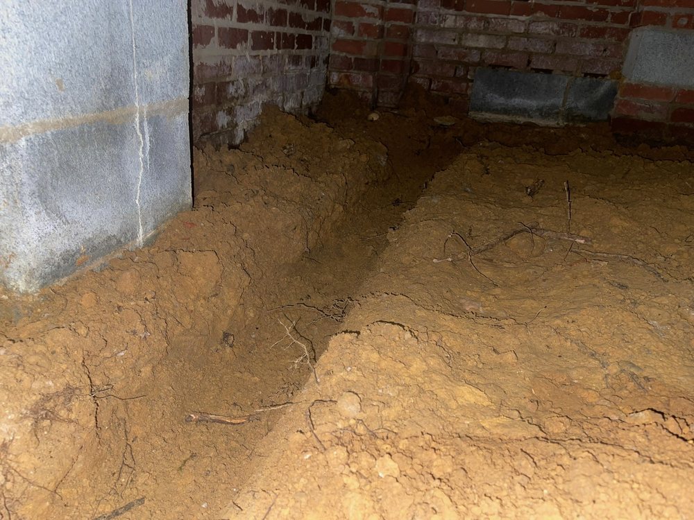Musty crawl space with exposed dirt floor