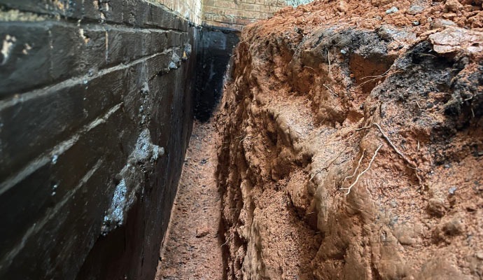 Foundation wall with exposed soil