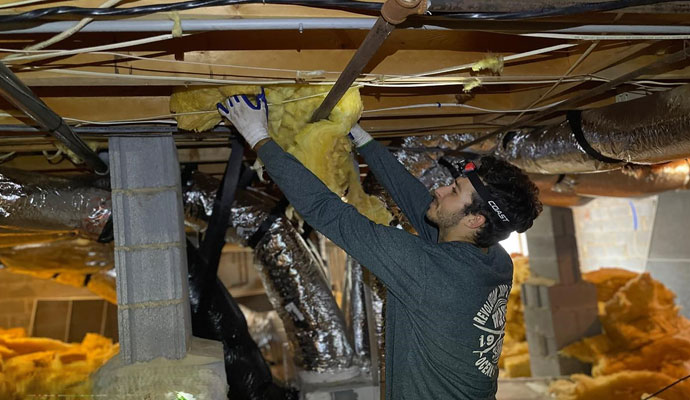 An expert is working for waterproofing a basement.