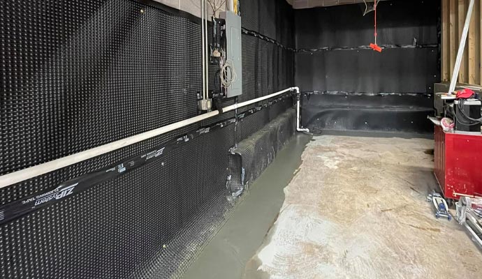 Basement waterproofing installation with a drainage system