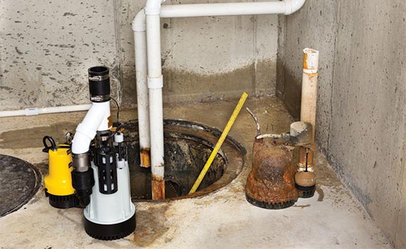 A new Sump pump and a old Damaged rusting Sump pump 