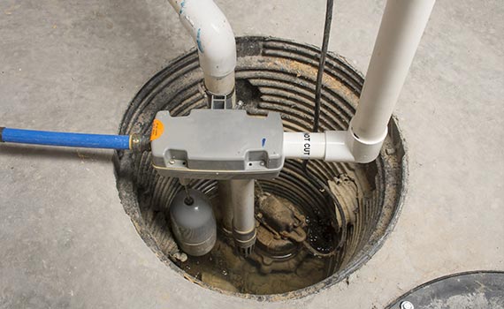 A sump pump system with battery backup installed in a basement